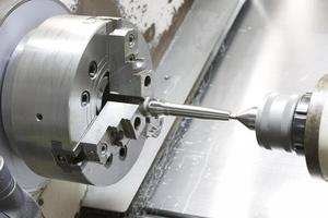 operator machining mold and die part by CNC turning machine
