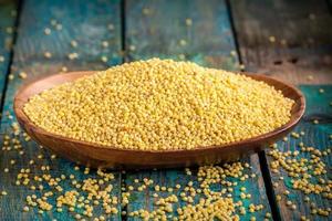 organic millet seeds in a wooden bowl photo