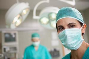 Surgeon standing in front of a colleague