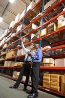 Two Businessmen With Digital Tablet In Warehouse photo