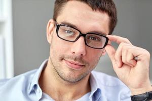 portrait of businessman in eyeglasses at office photo