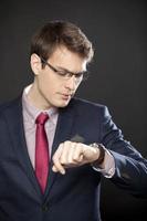 Handsome businessman looking at the time photo
