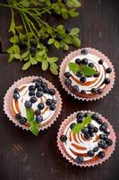 homemade cupcakes with icing and blueberries photo