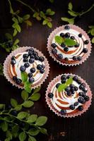 homemade cupcakes with icing and blueberries photo