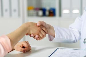 doctor shaking hand with patient photo