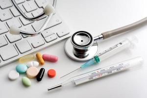 Stethoscope, pills, syringe, thermometer