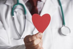 Close Up Of Doctor Holding Cardboard Heart