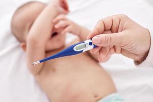 Fever, measuring temperature for little baby photo
