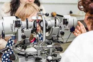 optometrista con paciente, dando un examen ocular foto