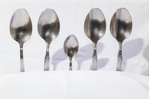 Spoons and forks on a white background photo