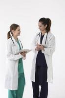 Two female healthcare workers wearing uniform and stethoscope. photo