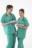Two female Healthcare workers reading Tablet device. photo