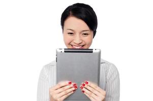 Shy pretty corporate lady holding tablet device photo