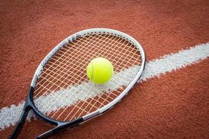 Tennis racket and ball on court photo