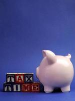 Piggy bank with Tax Time message on building blocks. photo