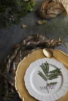 Holiday Gold place setting, napkin brown plaid, on grunge backgr photo