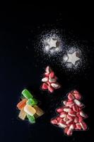Jelly Christmas trees and sugar stars in  biscuits  forms vertical photo