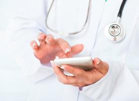 Doctor's hands with mobile phone
