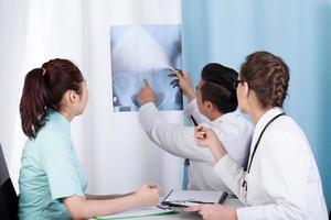 Doctors analyzing x-ray photo