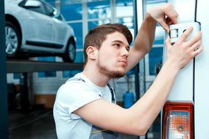 Car mechanic at the service station photo