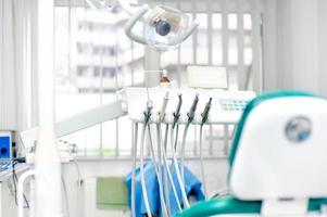 Modern dental clinic with tools, patient chair and equipment photo
