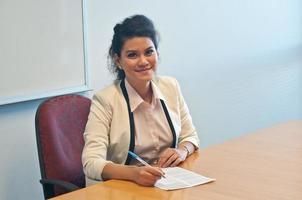 Business woman signing contract agreement in office