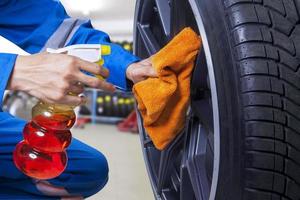 Technician cleaning a tire at workshop photo