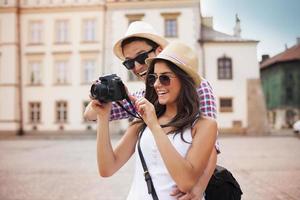 Young couple looks at photos on camera