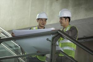 Two Asian industrial engineer's at work. photo