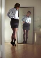 Businesswoman looking at herself in a mirror photo