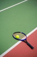 tennis racket and balls on the tennis court