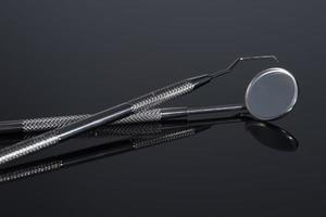Two Dental Tools, mirror and probe on Black background photo