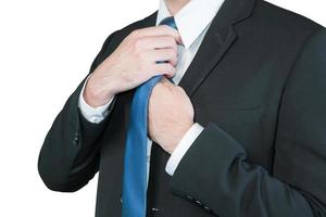 Well dressed business man adjusting his neck tie photo