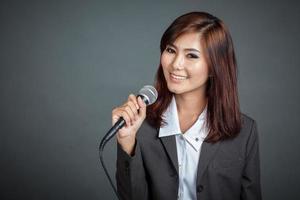 Close up of Asian business girl hold a microphone
