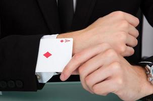 Businessman With Playing Cards In Sleeve photo