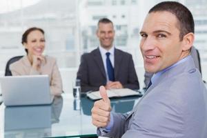 Applicant giving thumb up after obtaining the job photo