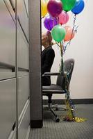 Businesswoman sat with bunch of balloons photo