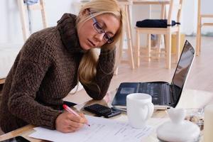Domestic economy. Woman checking bills at home