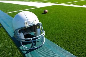 American Football Helmet on the Bench photo