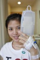 Patient hold her IV drip tube