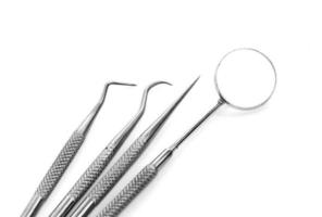 Basic dentist tools isolated on white photo