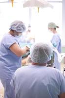 Team surgeon at work in operating room photo