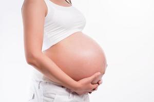 Beautiful pregnant woman on white background photo