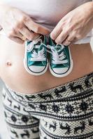 Pregnant belly with slippers photo