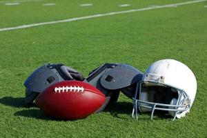 American Football and Helmet on the Field