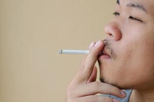Asian young man smoking cigarette