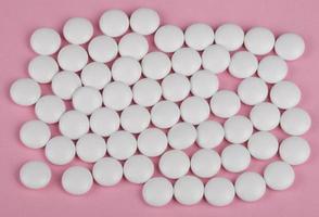 white pill on pink background photo