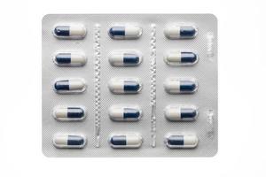 Dark blue capsules in blister pack closeup isolated photo