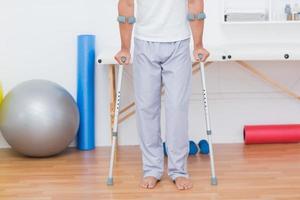 Patient standing with crutch photo