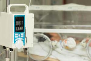 Infusion pump feeding IV drip into baby's patients